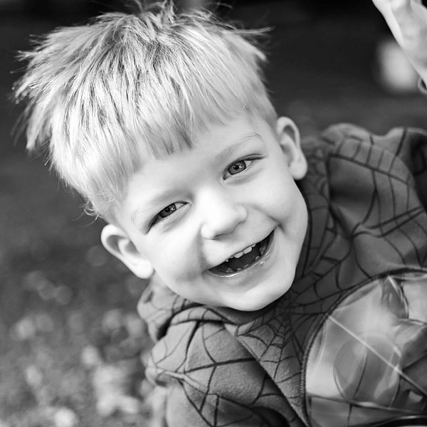 this is a black and white classic image of a boy laughing.  It was taken at his childcare centre.jpg